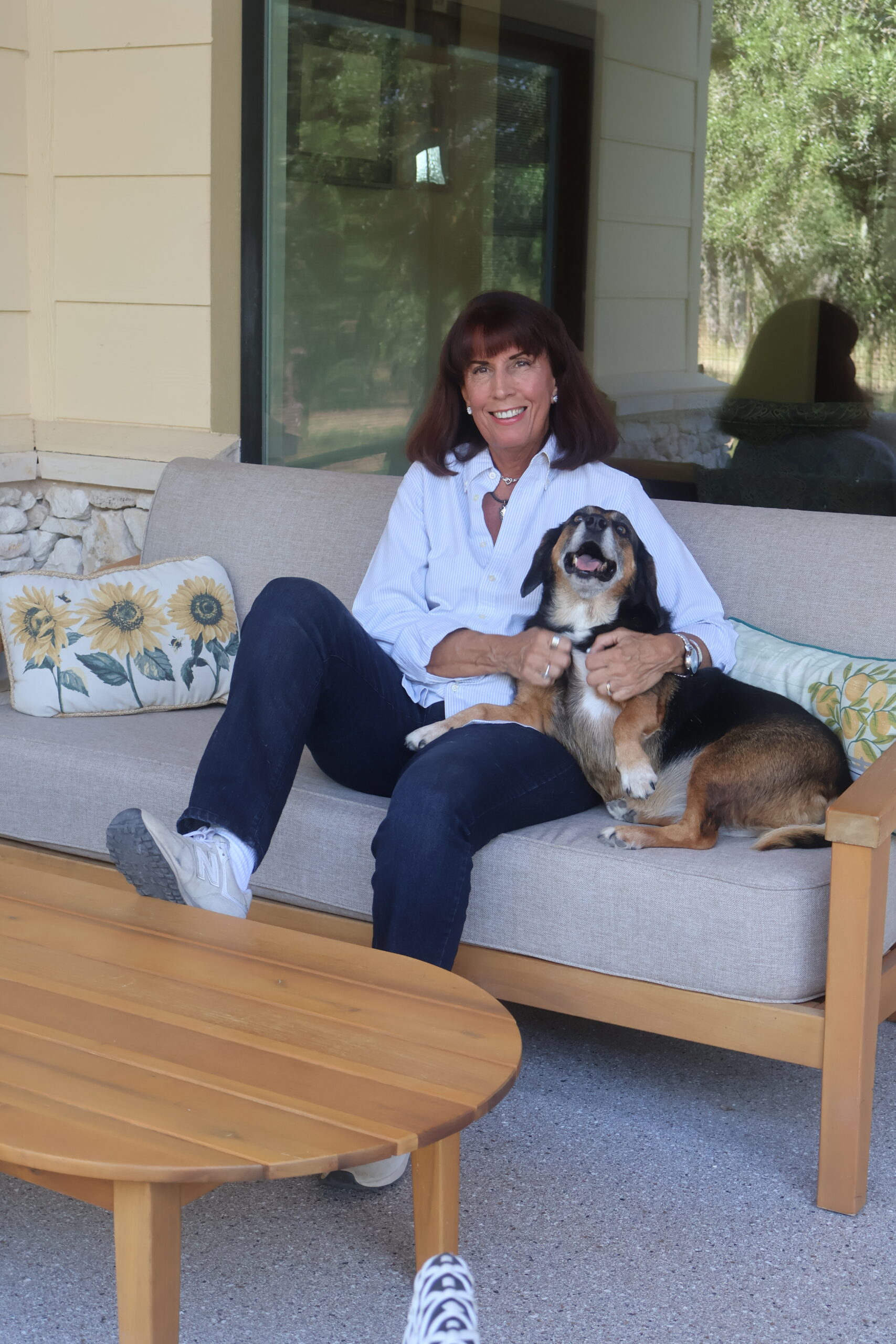 Mary Beth relaxing on the porch with her dog