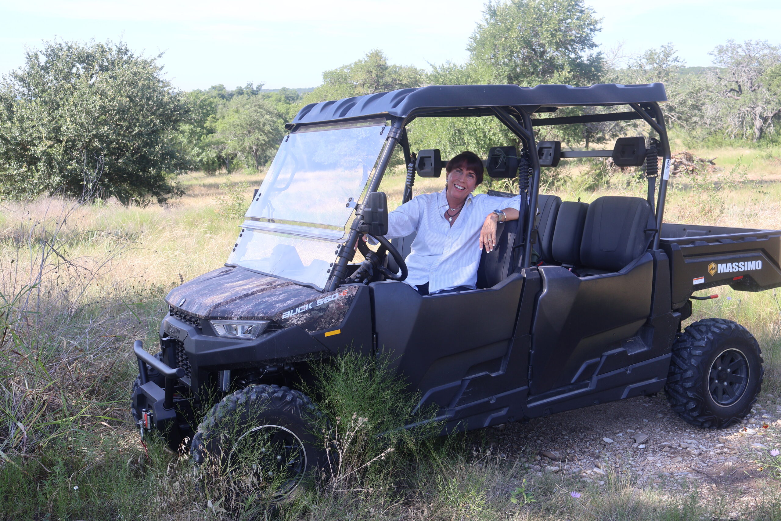 Mary Beth outdoors in a utility vehicle